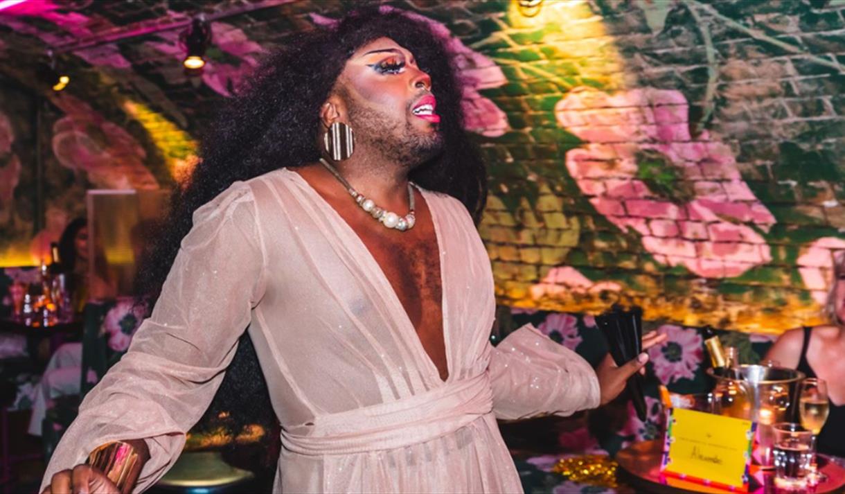 A drag queen serving