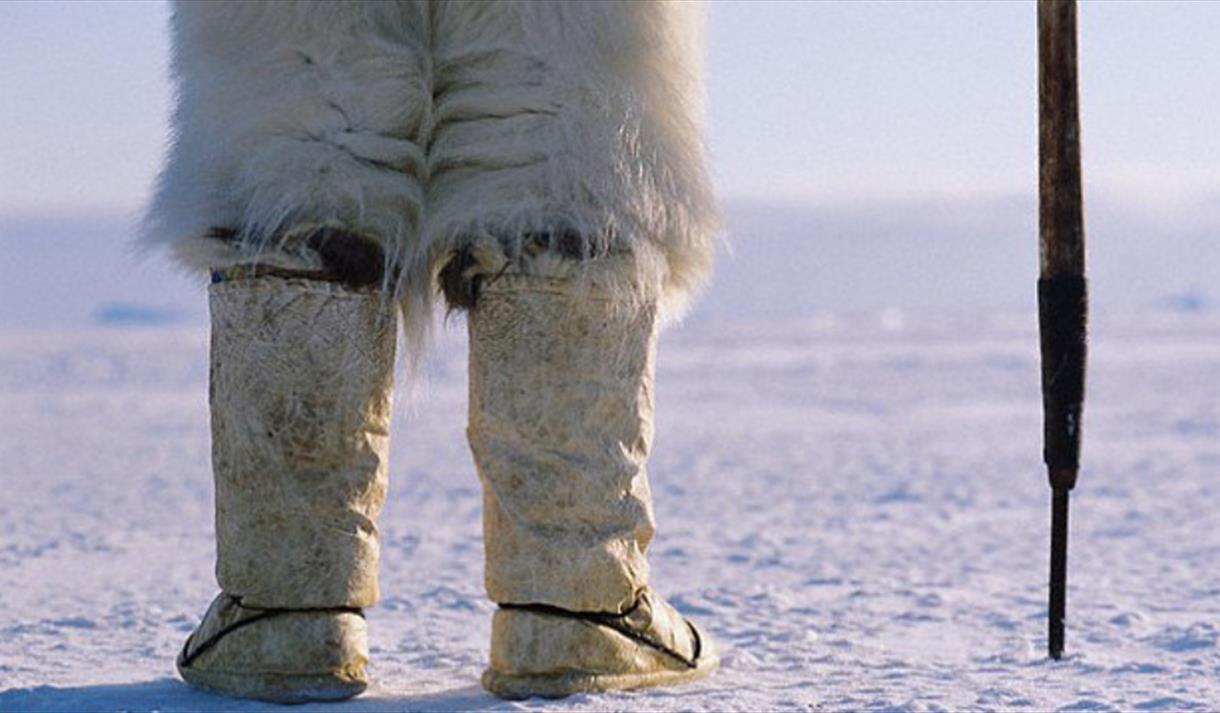 An eskimo stood in the snow