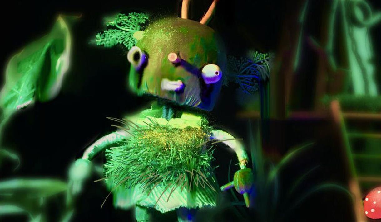 A green fluffy puppet