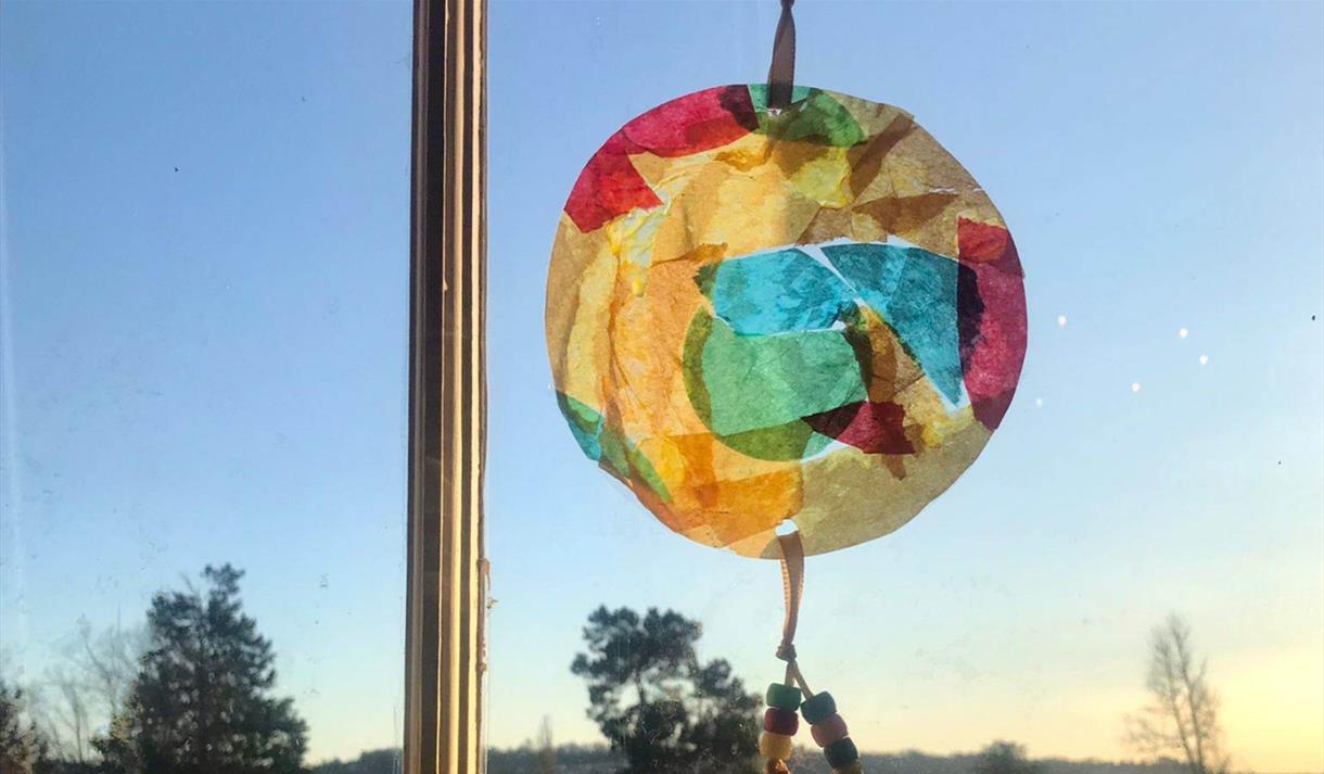 A photo of a suncatcher held against a window