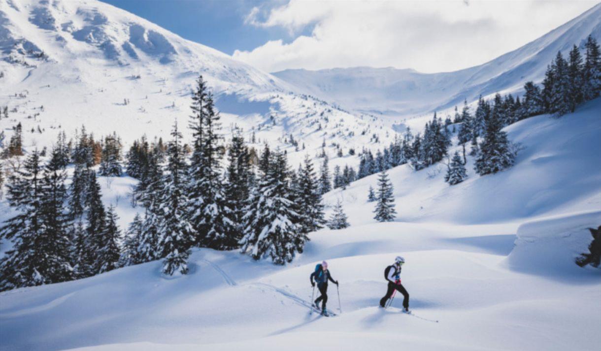 People walking through snowy mountains