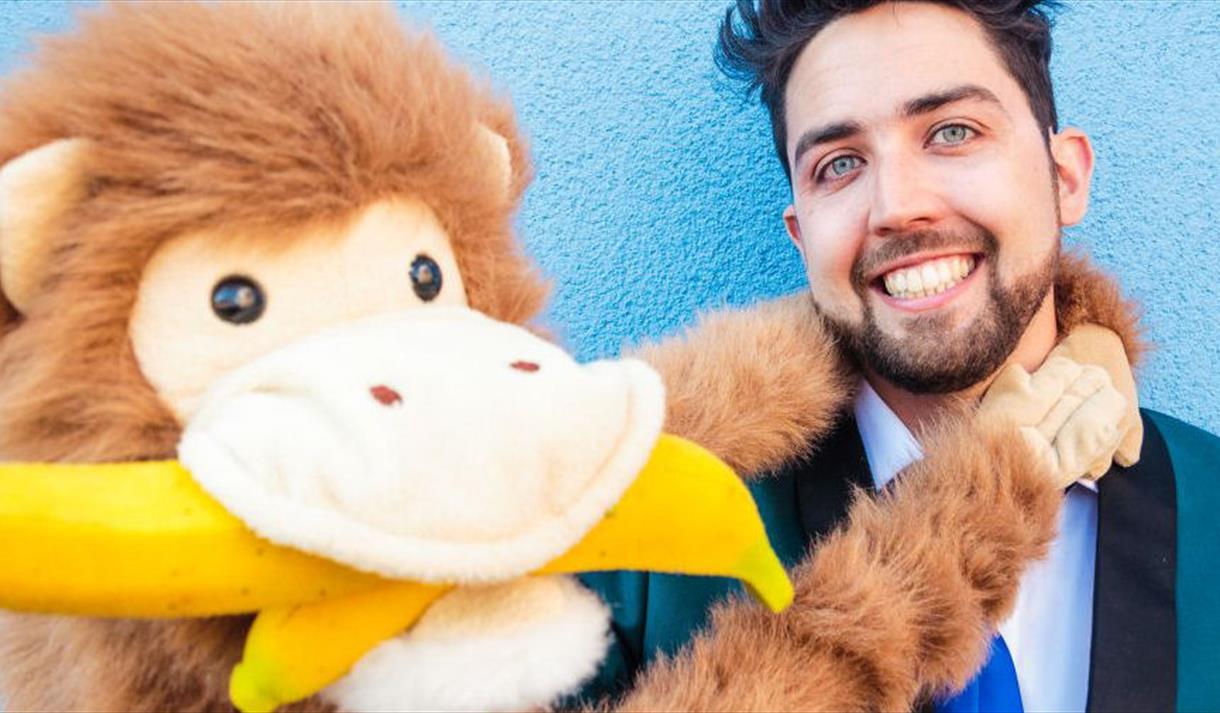 Marky Jay holding a monkey puppet