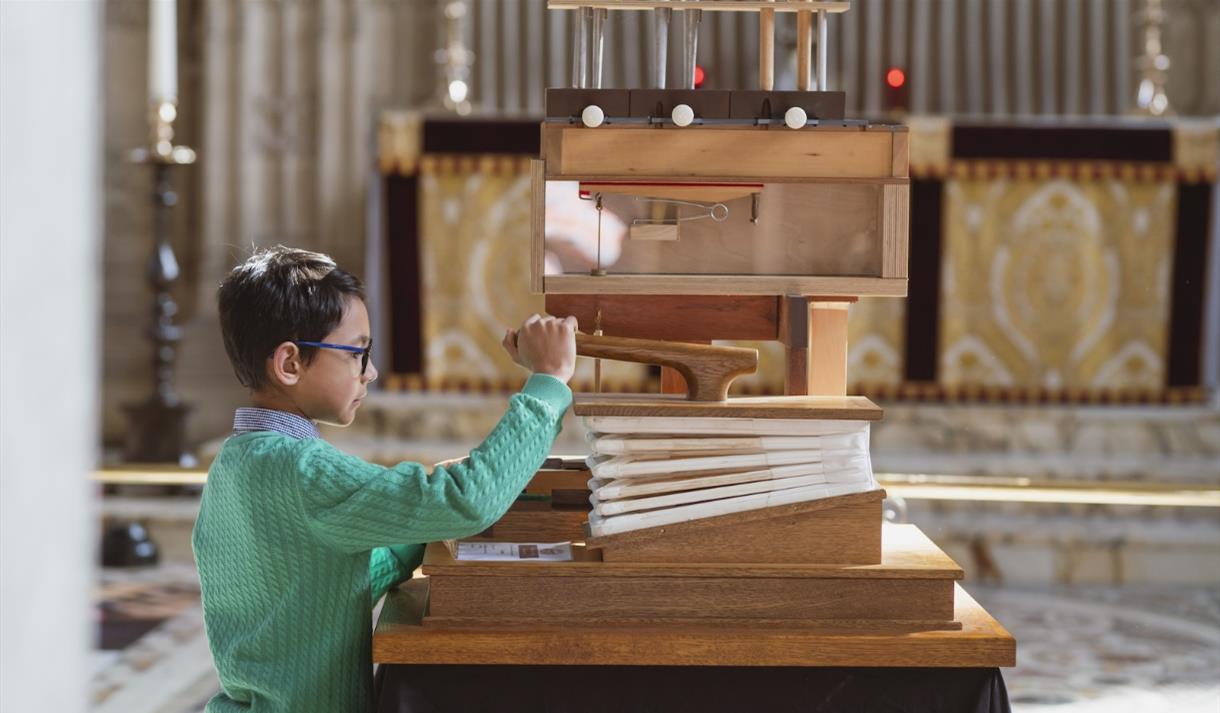 A young boy playing with an interactive exhibit