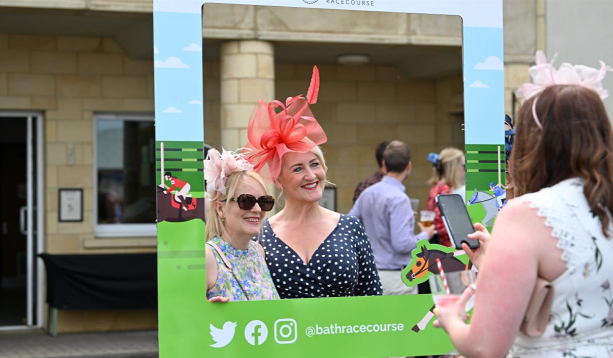 Two women posing for a photo in an Instagram frame