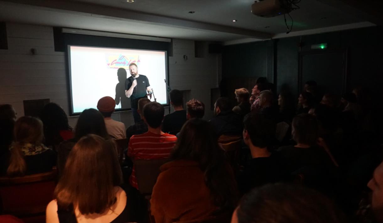 A man preform infront of a live audience