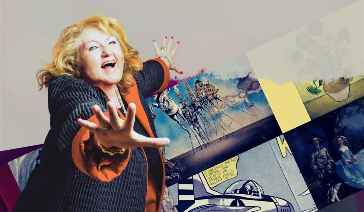 A woman smiling with hands out and art work in the background