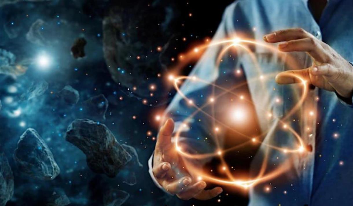 A man holding an atom