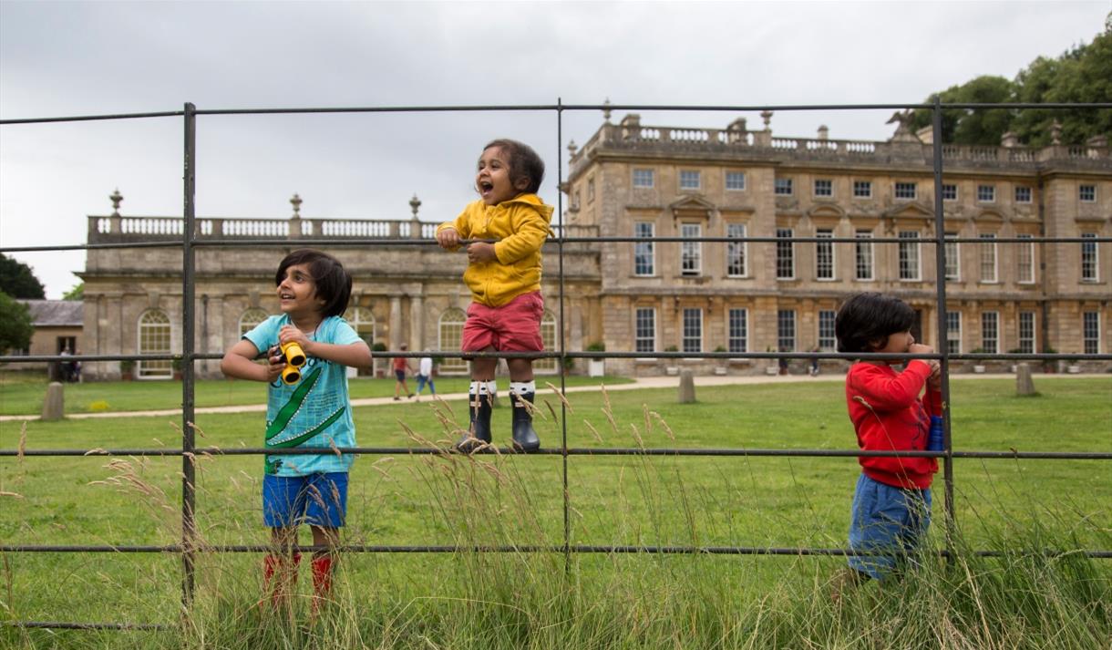 Children playing in front of a historic house