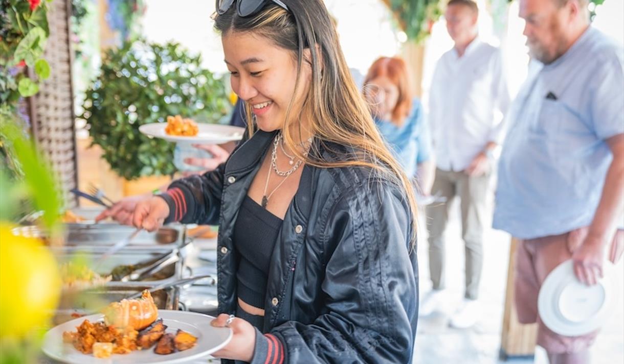 A women putting bbq food on a plate
