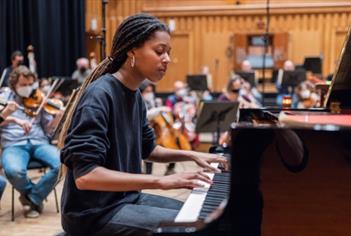 An image of a woman playing the piano