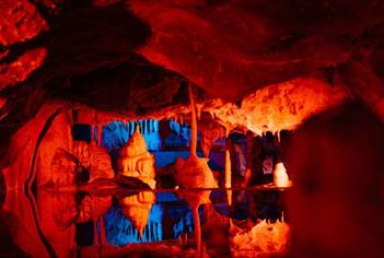Cheddar Caves lit up in red and blue
