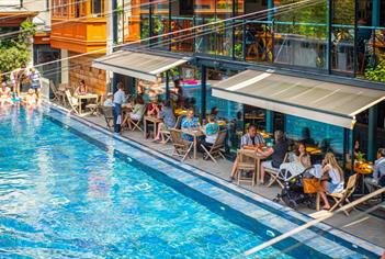 Bristol Lido poolside with people on chairs