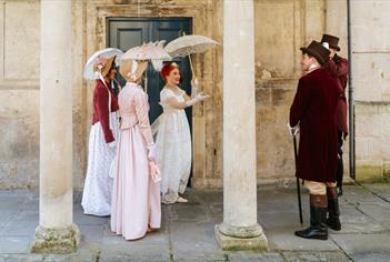 A group of people wearing Regency costume
