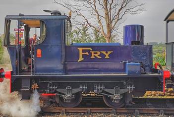 Blue locomotive with gold writing on it