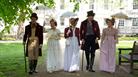 A group of people wearing Regency costume in Queen Square, Bath