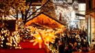 Bristol Christmas Markets 2022 Christmas lights and stalls with Cabot in background CREDIT James Bridle