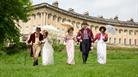 A grpoup of people wearing Regency costume at the Royal Crescent in Bath