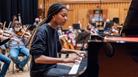 An image of a woman playing the piano