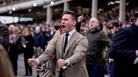 Cheltenham Festival men's style - male race goer dressed in suit in the grandstand