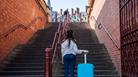 Woman with luggage in city