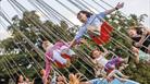 Children on fairground rides at Bristol Balloon Fiesta