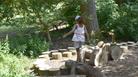 Girl on the balancing logs at Prior Park Landscape Garden