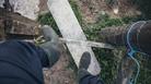 person wearing boots climbing over countryside stile