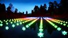 rows of illuminated stars shining outside in the darkness