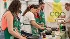 An image of people cooking at one of the demonstrations at Foodies Festival.