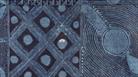 Close-up of a monochrome geometric artwork featuring intricate hand-drawn patterns in shades of dark blue and grey. The composition is divided into se