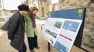 People reading an information board in the Abbey ruins in Reading