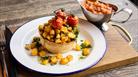 Brunch pie topped with potatoes and vine tomatos