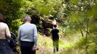 A family of three walking through woods