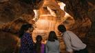 family in calcite cave