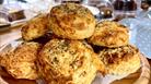 Cheese scones on a wooden plate.