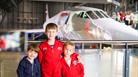 children in front of plane