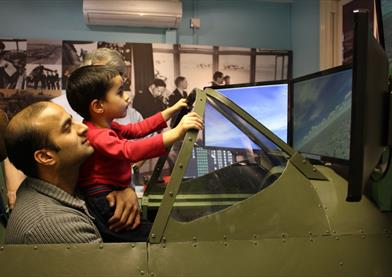 Maidenhead Heritage Centre: man and boy enjoying the Spitfire Simulator