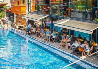 Bristol Lido poolside with people on chairs