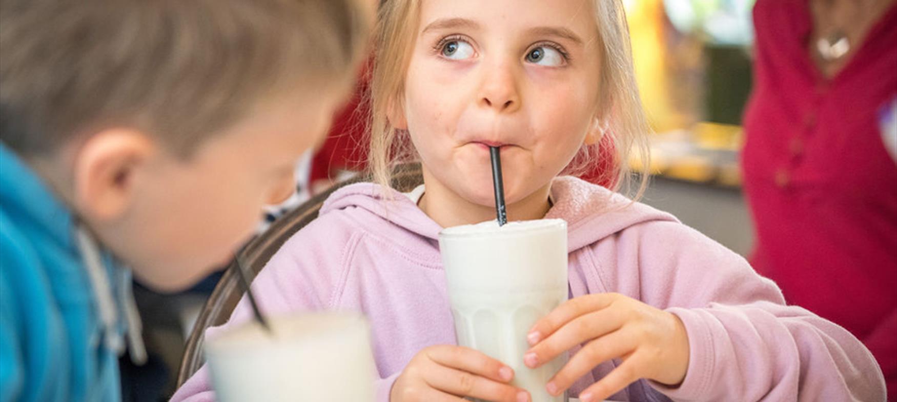 Young girl drinking milkshake