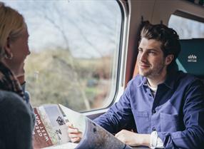Man and woman on train looking at map