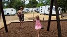 Playing on the swings at Chertsey Camping and Caravanning Club Site