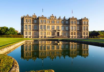 view of Longleat House, with reflection in fountain