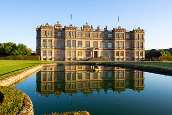 view of Longleat House, with reflection in fountain