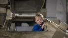 Boy exploring tank at REME Museum