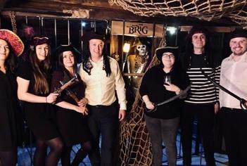 Players dressed as pirates in The Brig escape room