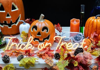 Halloween display with pumpkins, autumn leaves and neon lights