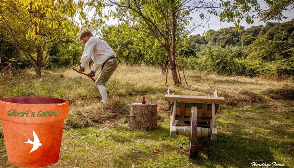 A man in period costume scything