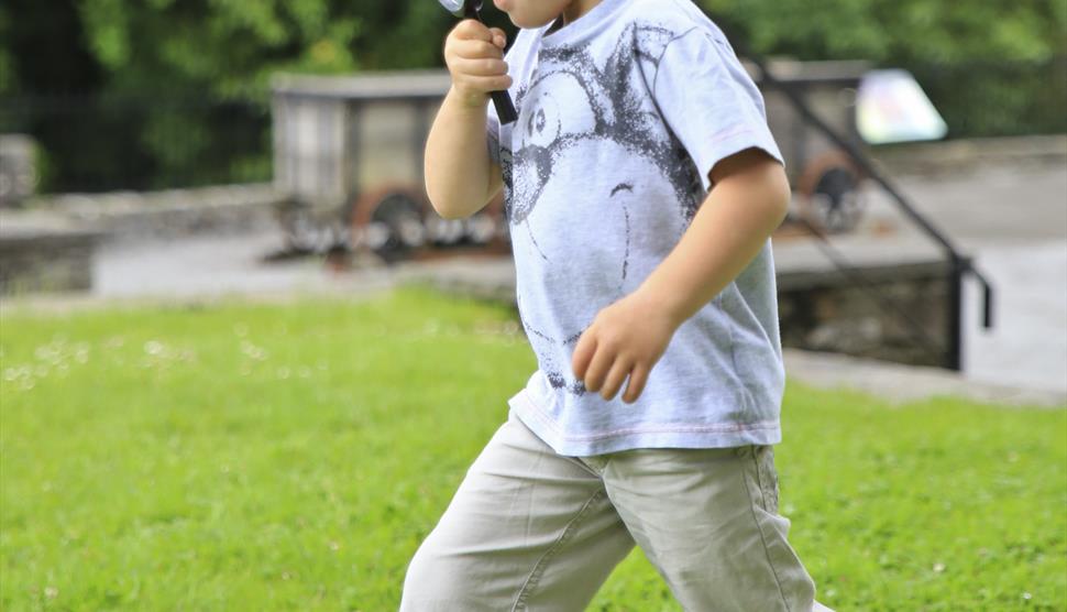A child looking through a magnifying glass