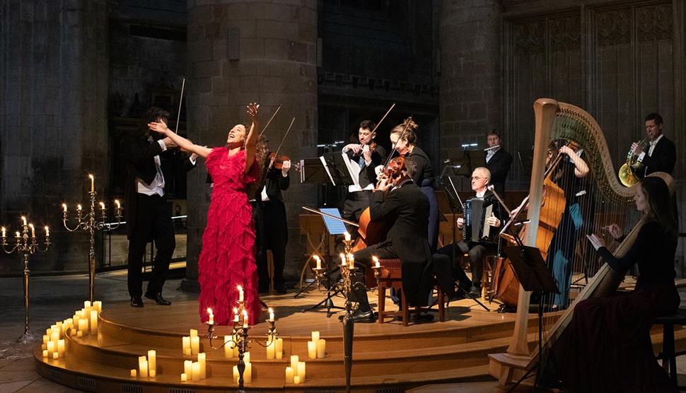An orchestra playing by candlelight.