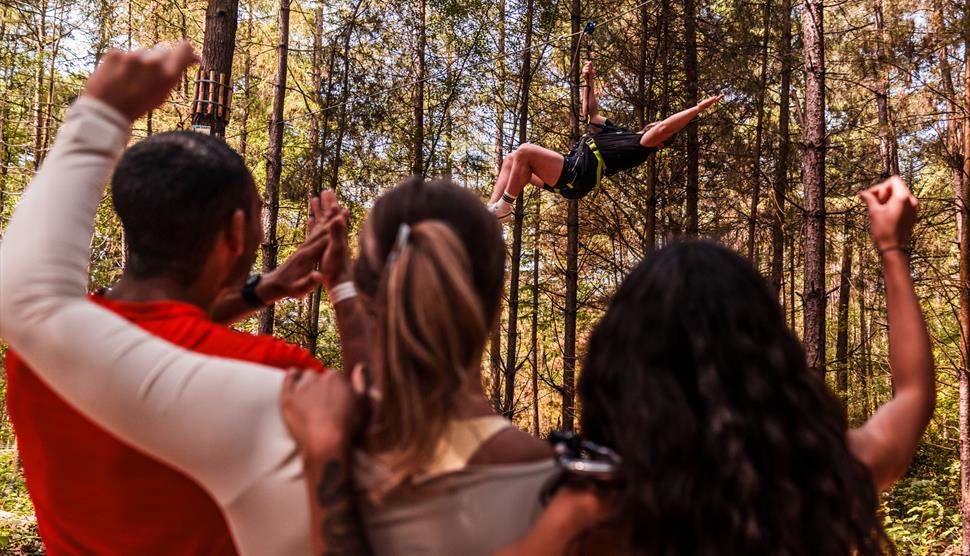 Adult on a zip line at Go Ape